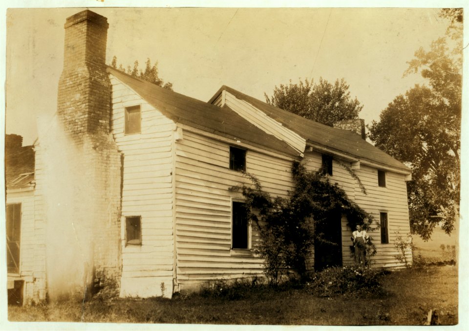 Home of Wyatt Pruett (in doorway). His father is a prosperous farmer but the boy stays out of school to work. Will go to Pruett School. LOC nclc.00504