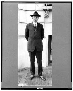 Homer Stillé Cummings, full-length portrait, standing, facing front with hand behind back, wearing hat LCCN91482974 photo