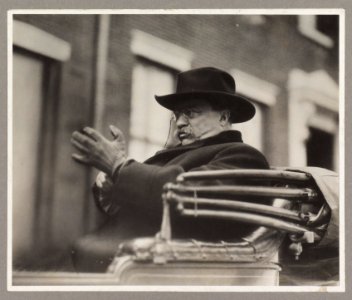 Hon. Theodore Roosevelt seated in a carriage, wearing hat LCCN2013651315