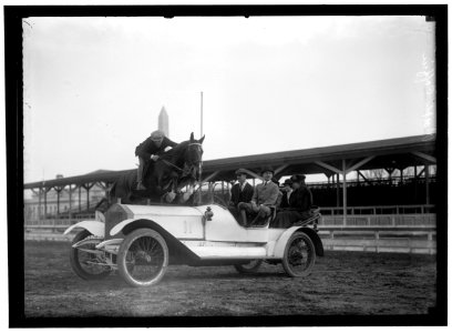 HORSE SHOWS. RALPH COFFIN JUMPING HIS HORSE OVER SYLVANUS STOKE'S ROLLS ROYCE LCCN2016866662