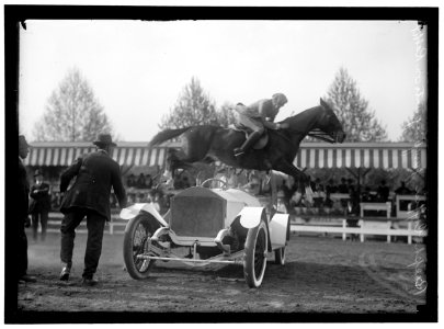 HORSE SHOWS. RALPH COFFIN JUMPING HIS HORSE OVER SYLVANUS STOKE'S ROLLS ROYCE LCCN2016867340