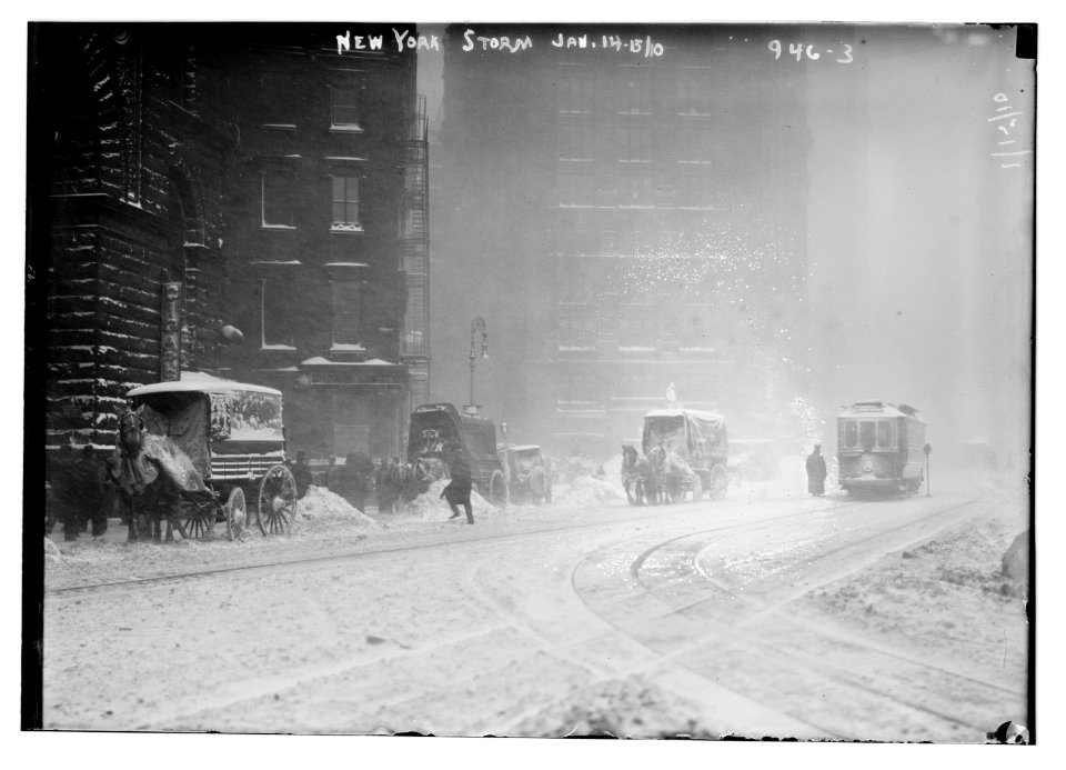 Horse-drawn wagons on snowy street, NY snow storm LCCN2014684455