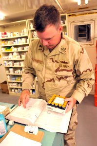 Hospital Corpsman 2nd Class Daniel McNally verifies the components of a medicine in the detention hospital, Dec. 29, 2010. DVIDS355339