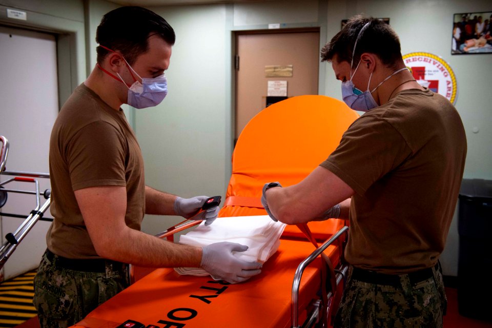 Hospitalman Austin Parson, left, and Hospitalman Apprentice James Bennett prepare a gurney for patient transport (49810883741)