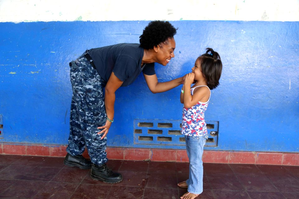 Hospitalman 3rd Class Mickieila Bryant plays with a child at a medical site. (18950746862)