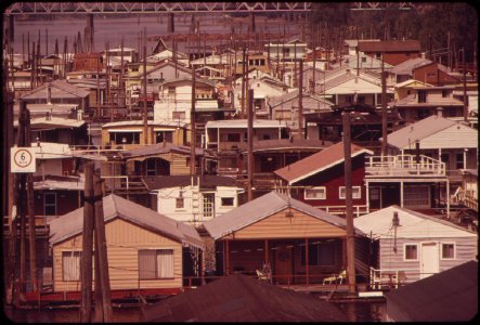 Houseboats-on-the-columbia-river-slough-near-the-interstate-5-freeway-and-industrial-area-in-background-is-the-interstate-bridge-which-connects-portland-with-vancouver-washington-051973 4271575367 o
