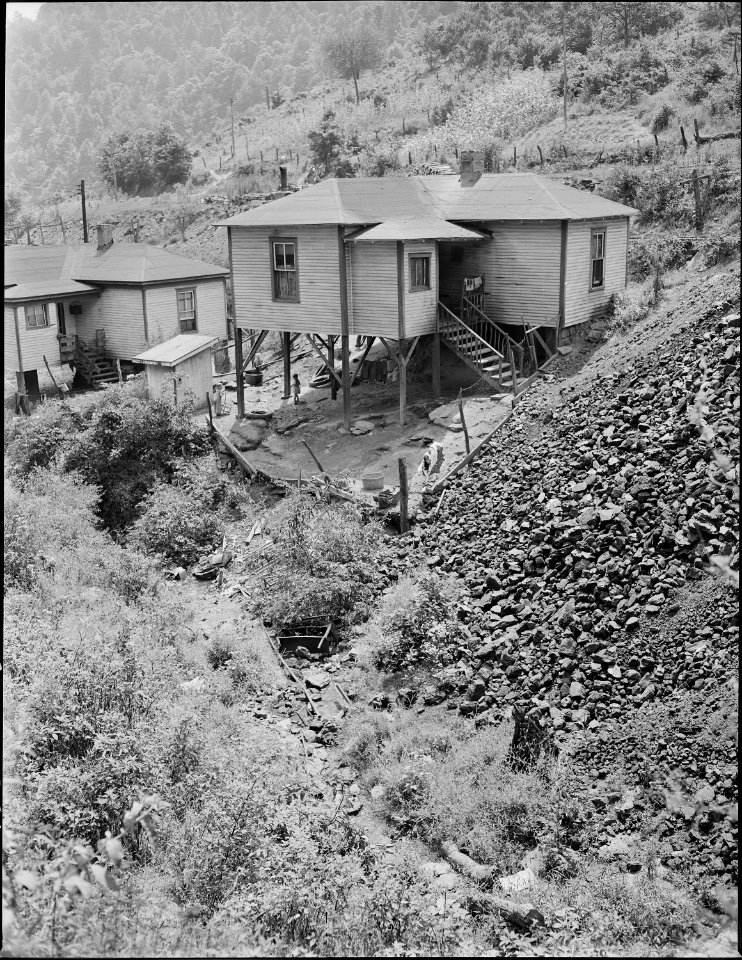 Houses and ditch. Mullens Smokeless Coal Company, Mullens Mine, Harmco, Wyoming County, West Virginia. - NARA - 540961