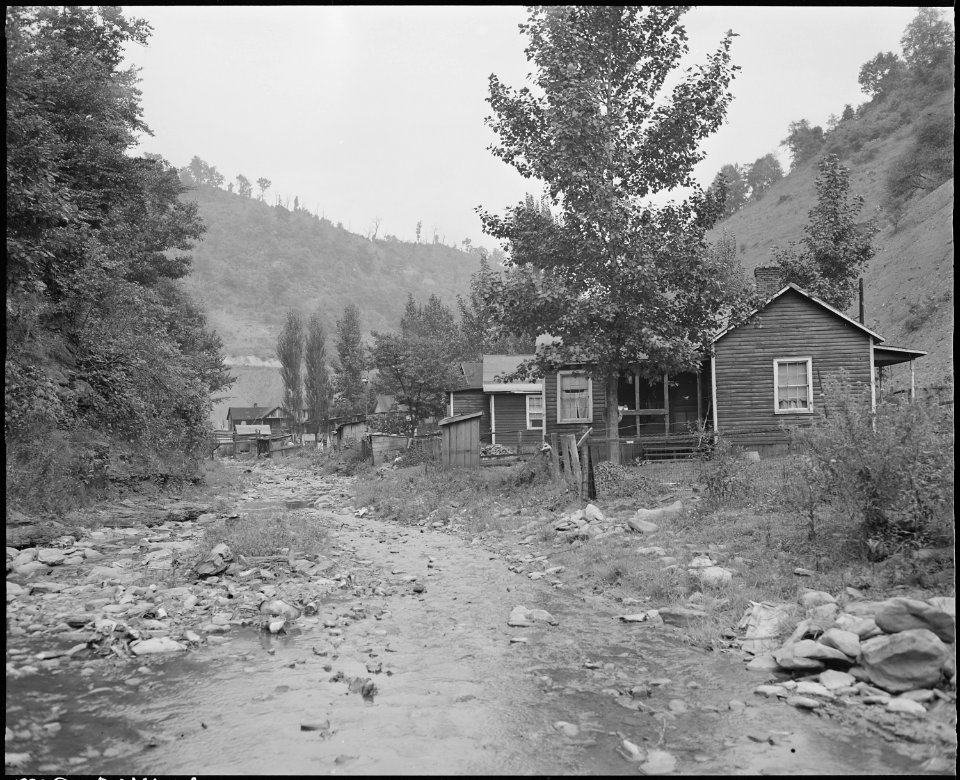 Houses along the stream, the only access to these houses is up this stream bed, and up railroad track. Furniture... - NARA - 541115