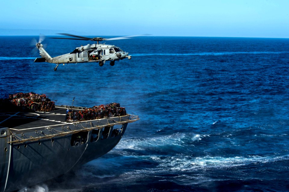 HSC-21 MH-60S Sea Hawk helihoisting supplies from USNS Henry J. Kaiser (T-AO-187) during vertical replenishment of USS Anchorage (LPD-23) during Essex ARG COMTUEX (150325-N-BD107-267)