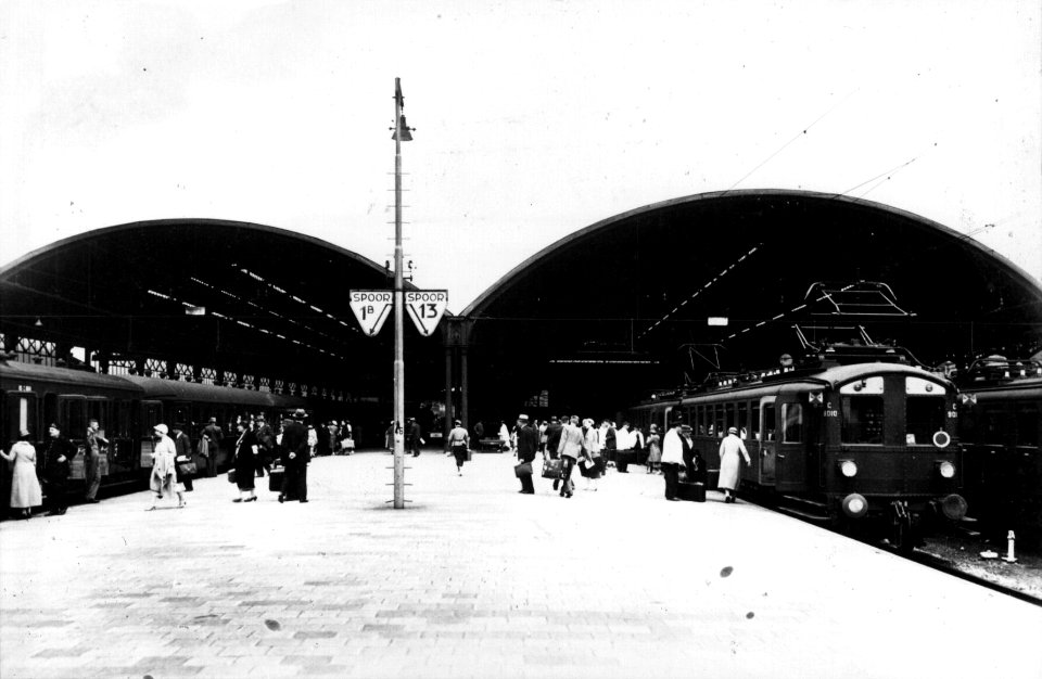 HUA-154660-Gezicht op het perron met perronkappen van het N.S.-station Rotterdam D.P. te Rotterdam met instappende reizigers in een trein bestaande uit rijtuigen electrisch buffermaterieel (mat. 1924, blokkendo