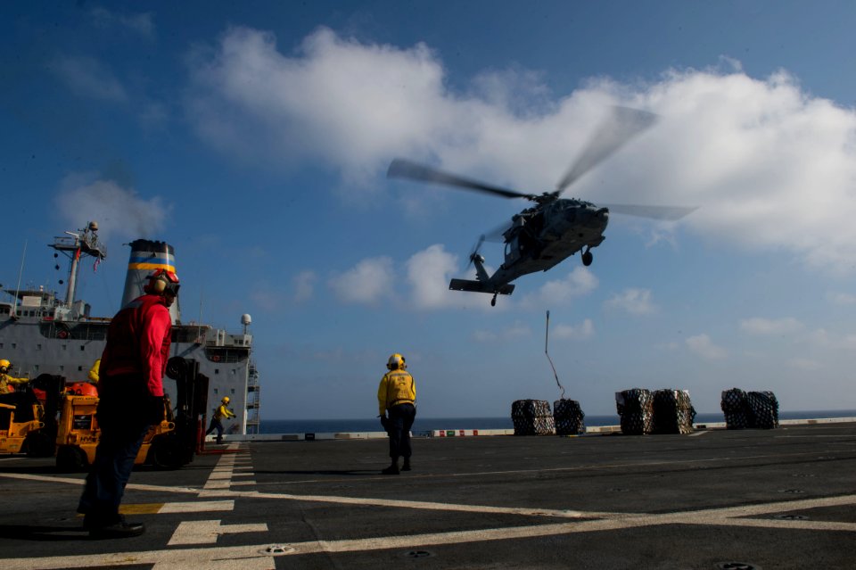 HSC-23 MH-60S Sea Hawk delivering supplies to USS New Orleans (LPD-18) 160411-N-GR718-382