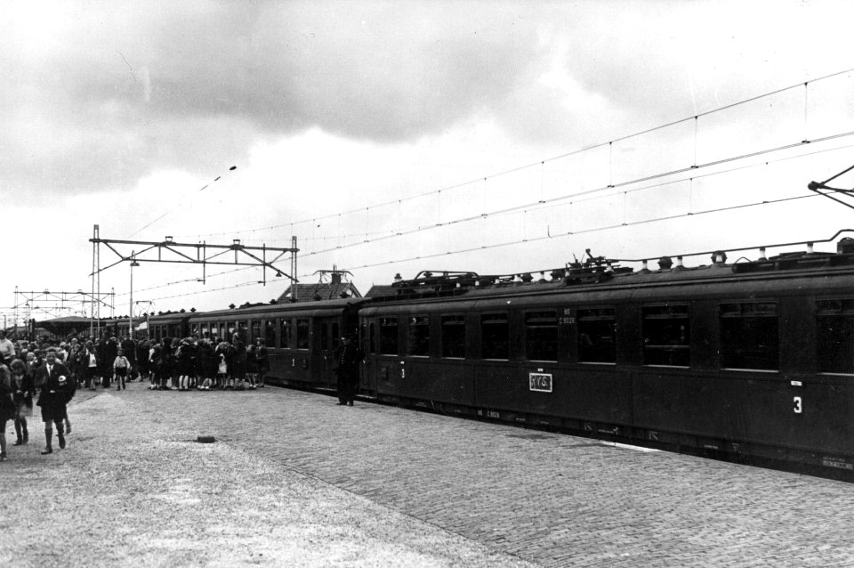 HUA-152942-Afbeelding van uitstappende scholieren uit een trein bestaande uit rijtuigen van het electrisch buffermaterieel blokkendozen mat 1924 van de NS met re