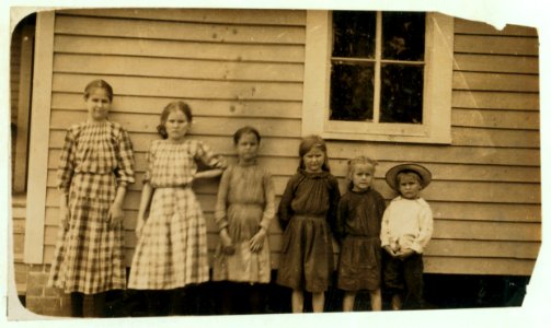 Hughes children. All except two smallest work and help in Magnolia, (Miss.) Cotton Mill. Oldest is fifteen, next is fourteen, next eleven, next ten. 'We like the work first rate.' LOC nclc.02036 photo