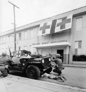 Humanitarian G.I.'s. Firefight where G.I. pushes little kid under jeep for protection, Santo Domingo, May 5., 1965 - NARA - 541806 (cropped)