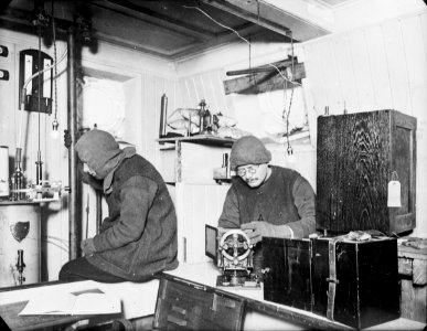 Hussey and James working in the laboratory onboard 'Endurance' (1912) RMG P00012