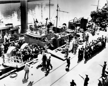 Icarus disembarking surviving U-352 crew members at the Charleston Navy Yard in Charleston, South Carolina