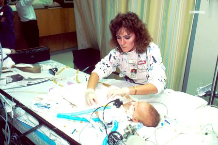 ICU nurse cares for infant photo