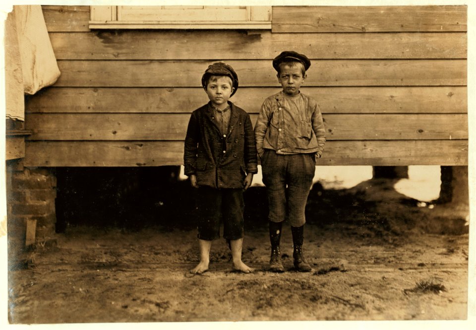 In neighborhood of Maple Mill, Dillon, S.C. Lawrence Faircloth (taller boy) 'Don't know how old I am.' Been in mill 2 years. Runs 3 sides Albert Bartlett (barefoot) Looked 8 years old. In LOC nclc.01456