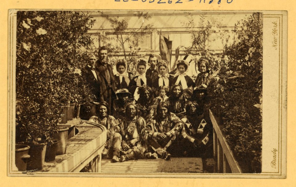 Indian delegation in the White House Conservatory during the Civil War, with J.G. Nicolay, President Abraham Lincoln's secretary, standing in center back row and interpreter John Simpson LCCN2004669812
