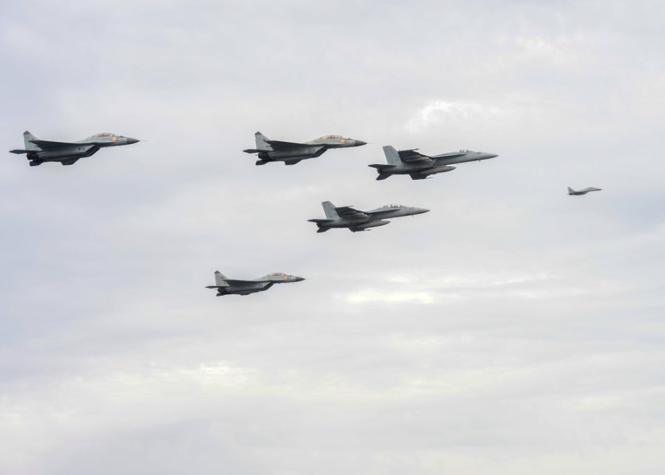 Indian Navy MIG-29K Fulcrums fly over the aircraft carrier USS Nimitz (CVN 68) during Exercise Malabar 2017