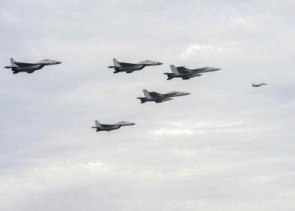 Indian Navy MIG-29K Fulcrums fly over the aircraft carrier USS Nimitz (CVN 68) during Exercise Malabar 2017