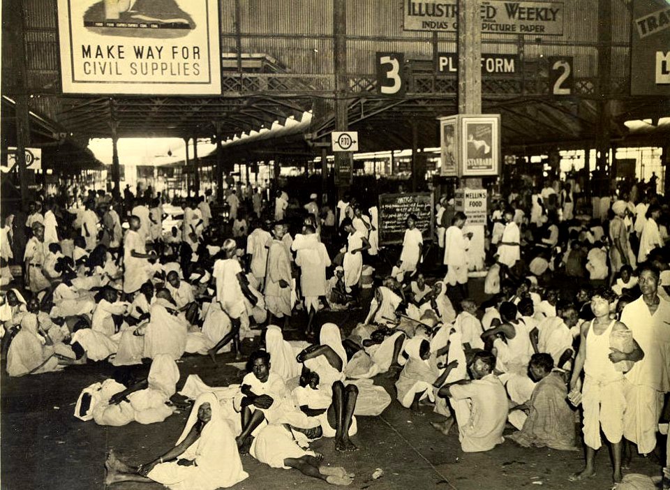 Indian travelers waiting at a railway station in Calcutta due to wartime transportation priorities in 1945
