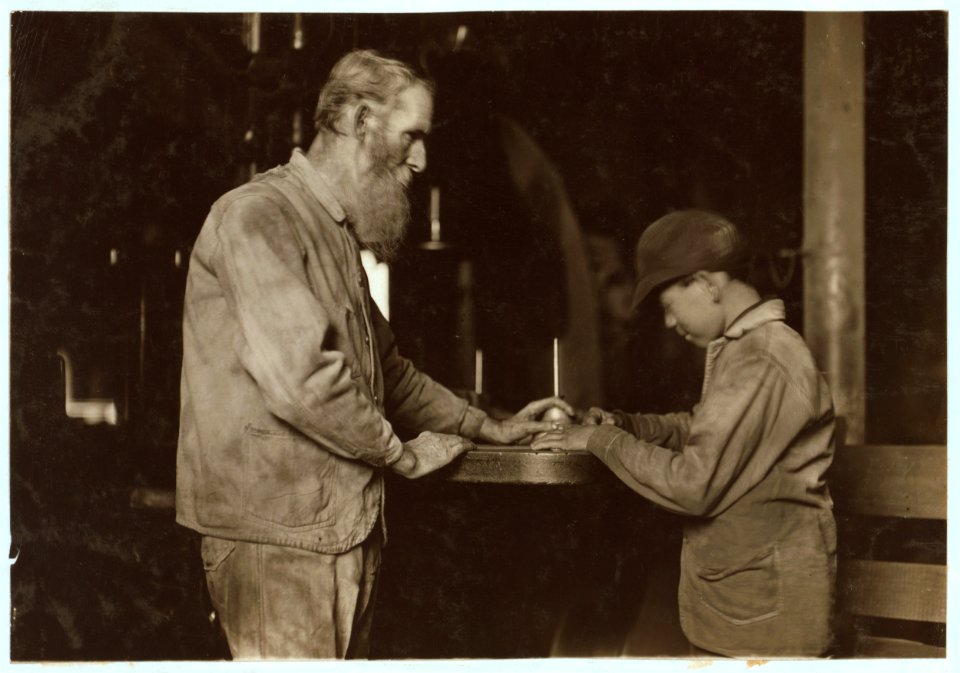 Indiana Mfg. Co. Peru, Ind. The old and the new. Old man has been there 33 years. Boy starting in, working with a board saw. LOC nclc.04486