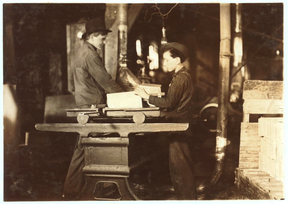 Indiana Mfg. Co., Boy working at circular saw. A number of young boys here working around saws, belts, planing machines, etc. LOC nclc.04489
