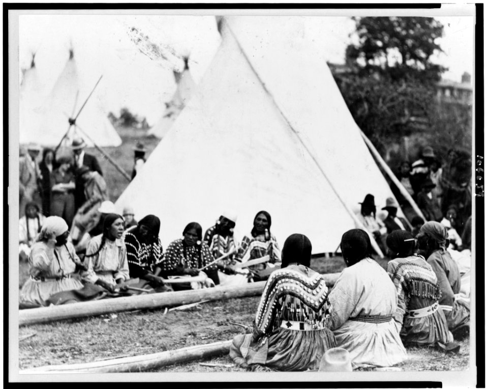 Indian women playing the stick game at the midsummer celebration on the Glacier National Park Reservation, Montana LCCN92515789