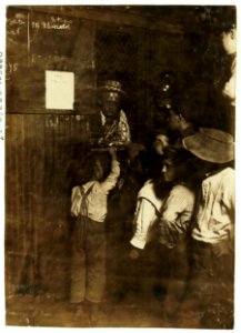 Indianapolis Newsboys buying brass checks in a newspaper office. These checks cost at the rate of one-half the selling price of the newspaper and are exchanged at another window for the LOC cph.3c05660
