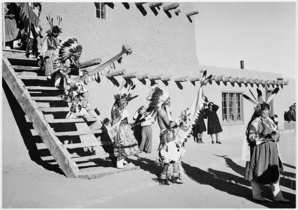 Indians in headdress, male and female, descending stairs, Dance, San Ildefonso Pueblo, New Mexico., 1933 - 1942 - NARA - 519982