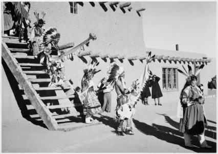 Indians in headdress, male and female, descending stairs, Dance, San Ildefonso Pueblo, New Mexico., 1933 - 1942 - NARA - 519982