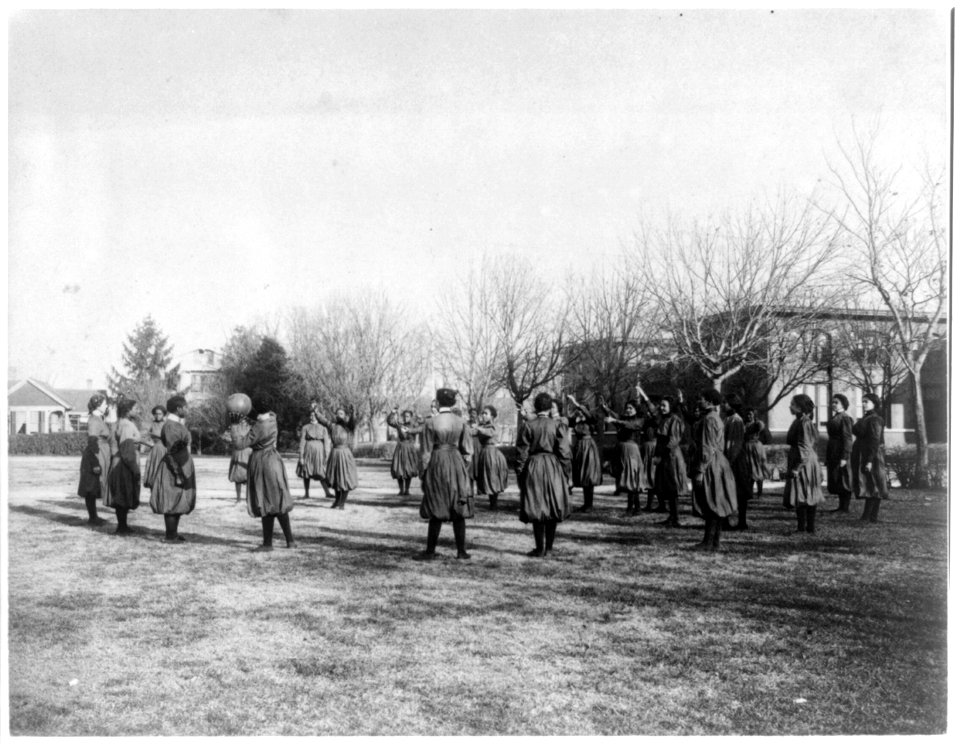 Indian and black girls exercising with medicine ball, Hampton Institute LCCN2001703736