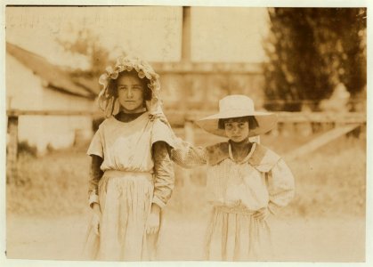 Inez Johnson (9 years old) and Lily, her cousin (7 years old). Both were helping Mrs. Johnson, a spooler in Tupelo (Miss.) Cotton Mills. Inez said she works regularly. LOC nclc.02138