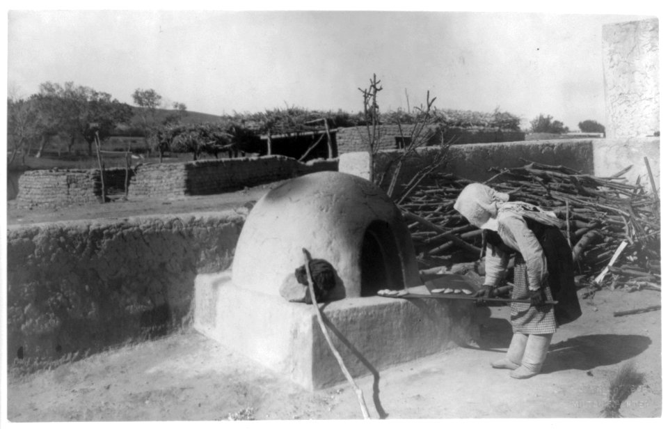 Indian woman baking in outdoor oven. Par-dah-weh; Southwestern U.S. LCCN2007677269