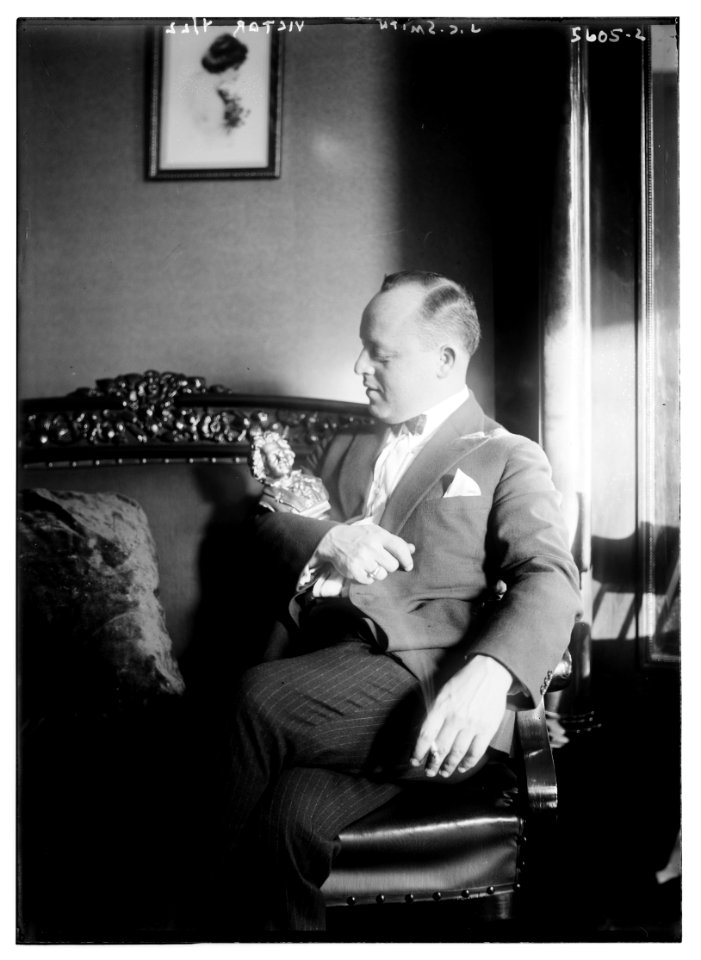 J.C. Smith (siting with small statue in his arms) LCCN2014713602