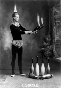 J.T. Doyle (holding 2 burning juggling clubs) LCCN2003671131