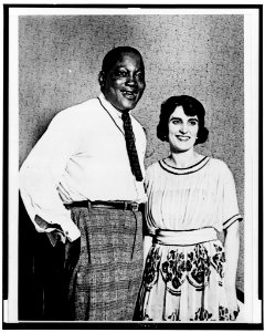 Jack Johnson and wife, three-quarter length portrait, facing slightly right LCCN98510494