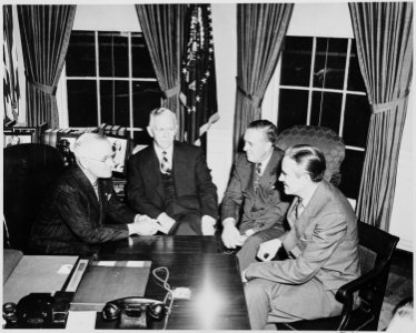 L to R, President Truman, George C. Marshall, Paul Hoffman, and Averell Harriman in the oval office discussing the... - NARA - 200035 photo