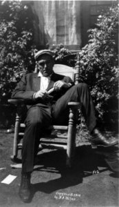 James J. Jeffries, full-length portrait, seated outdoors in rocking chair, facing front LCCN96513960