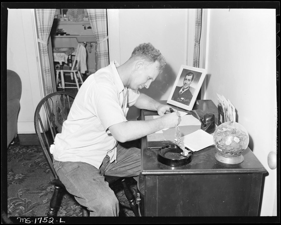 James Jasper, motor brakeman, writes a letter in his home in company housing project. Koppers Coal Division... - NARA - 540914