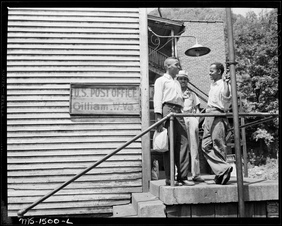 James Robert Howard, right, visits with fellow miners at the post office. Howard works the night shift. Gilliam Coal... - NARA - 540822