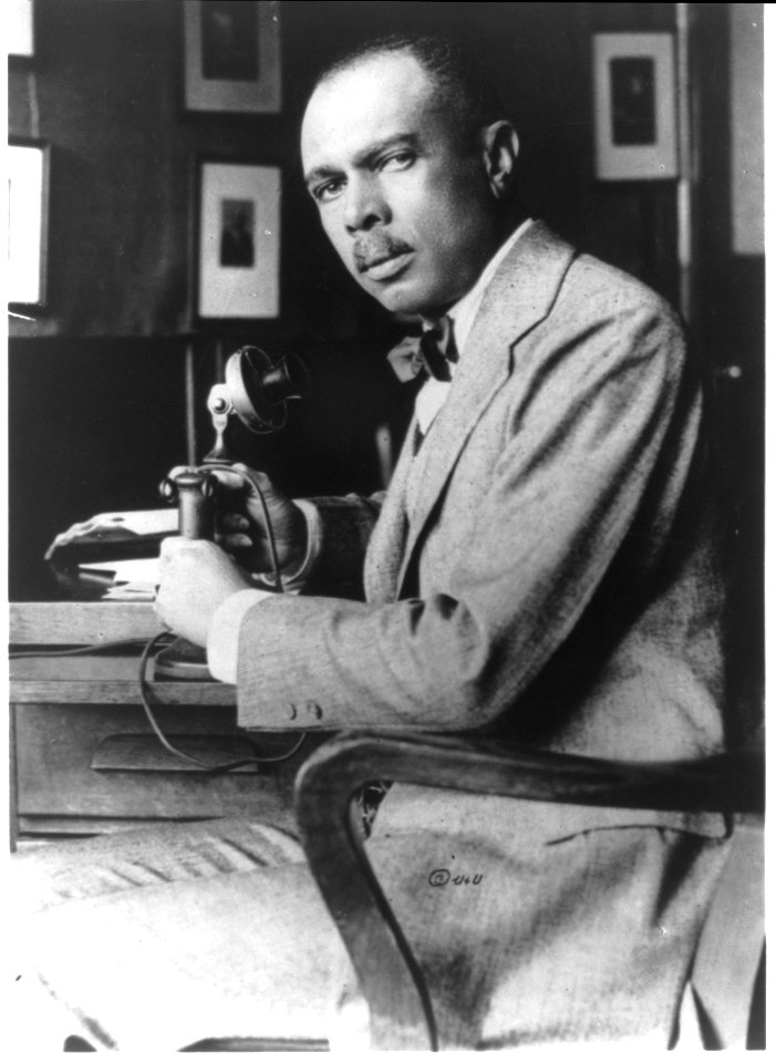 James Weldon Johnson, half-length portrait at desk with telephone LCCN95518635