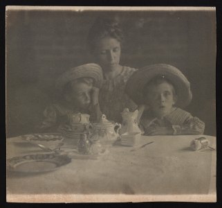 Jane White with sons Lewis and Maynard White seated at dining table with teacups LOC ds.10666