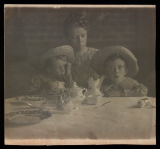 Jane White with sons Lewis and Maynard White seated at dining table with teacups LOC ds.10666