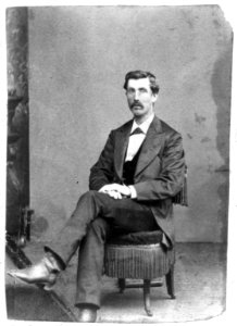 Jeff Whitman, full-length portrait, seated, facing left LCCN97505137