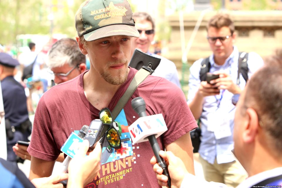 Jesse Gonzalez of Lakewood, Ohio, who carried his rifle with him, speaks to the media after arriving near the Republican National Convention in downtown Cleveland, July 18, 2016