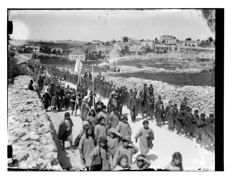 Jewish children and adults, one holding a Star of David banner, walking south on Nablus Road towards the grave of Shimon Hatzadik (Simon the Just), Jerusalem LOC matpc.11748