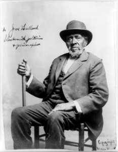 Joe Ballard, three-quarters length, seated, facing slightly left, blacksmith, politican, and philosopher LCCN2006687454