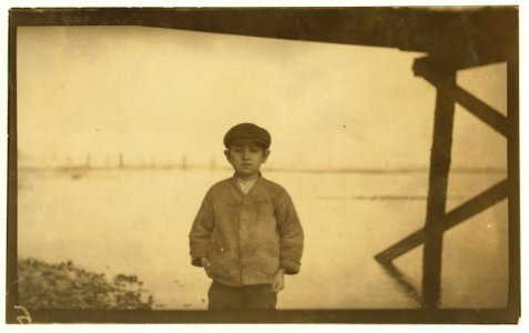 Joe Davis, a ten-year old going home from cannery at 5 P.M. He said he had shucked ten pots since 4 A.M. that day. LOC nclc.01037